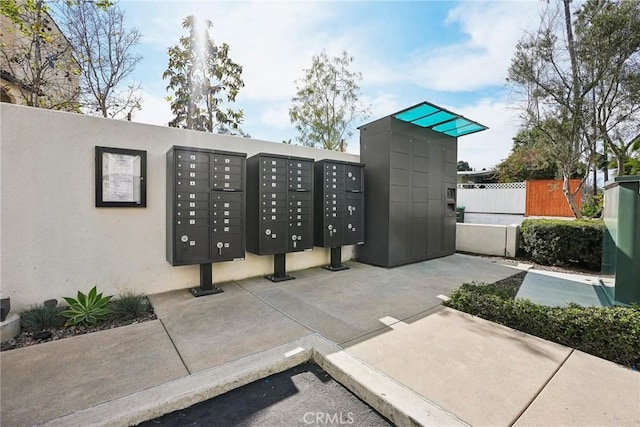 surrounding community featuring fence and mail area