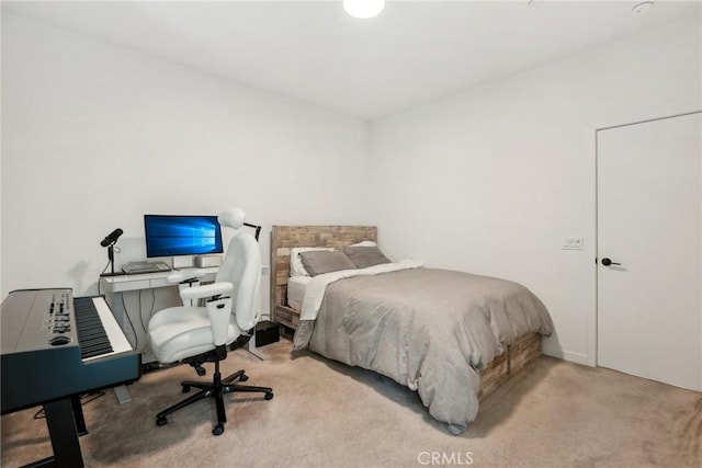 bedroom featuring light carpet