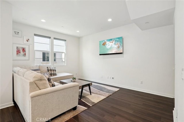 living room featuring recessed lighting, dark wood finished floors, and baseboards