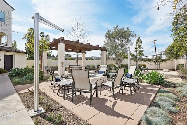 view of patio / terrace featuring fence, a pergola, and outdoor dining space