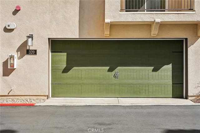 property entrance with a balcony and stucco siding