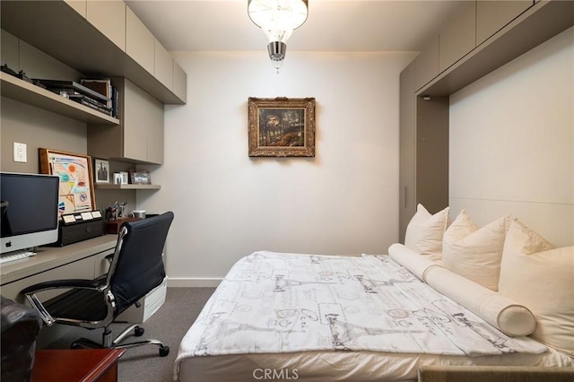 bedroom with baseboards and dark carpet