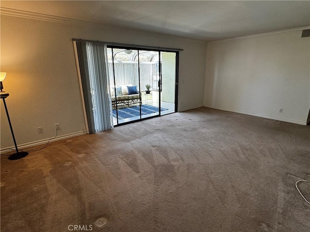 carpeted spare room with baseboards and ornamental molding