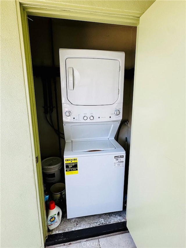 laundry area featuring laundry area and stacked washer / dryer