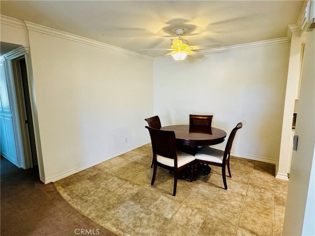 dining area featuring ornamental molding, baseboards, and a ceiling fan