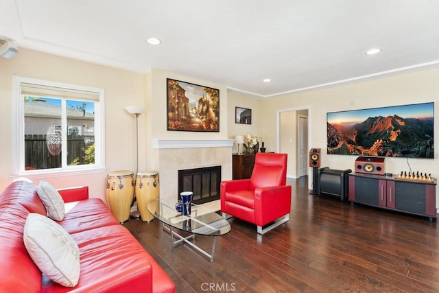 living area with a premium fireplace, dark wood-style flooring, and recessed lighting