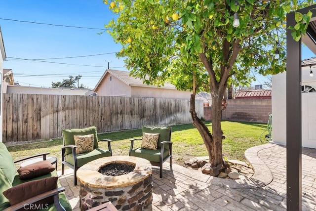 view of patio featuring an outdoor fire pit and a fenced backyard