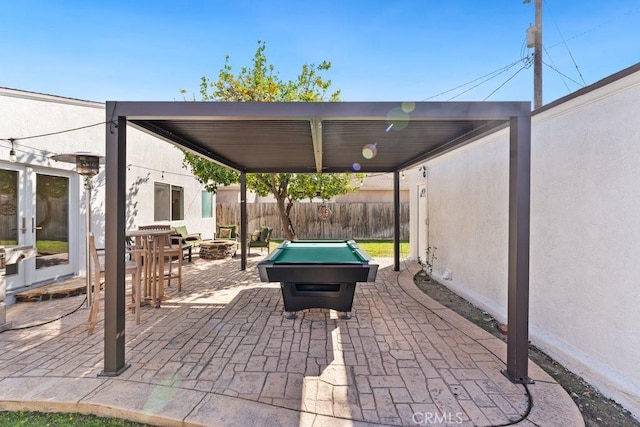 view of patio / terrace with a fire pit and fence