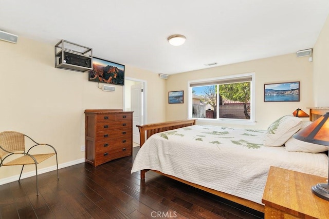 bedroom featuring dark wood-style floors, visible vents, and baseboards