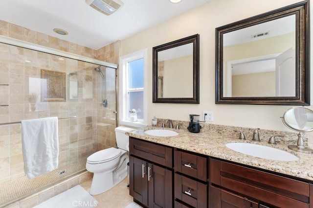 bathroom with toilet, a stall shower, a sink, and visible vents