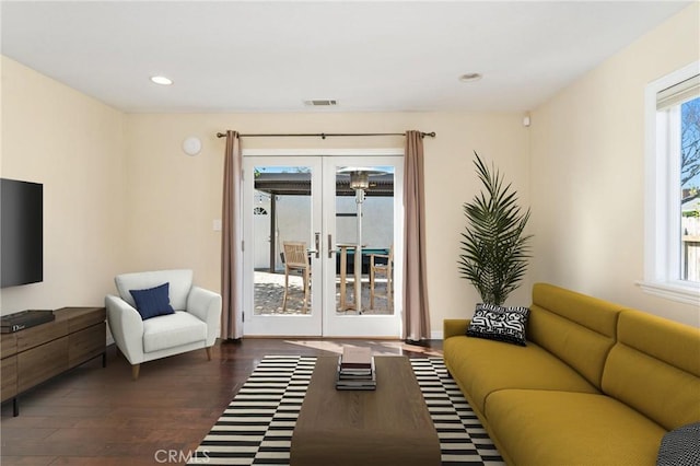 living room featuring recessed lighting, visible vents, dark wood finished floors, and french doors