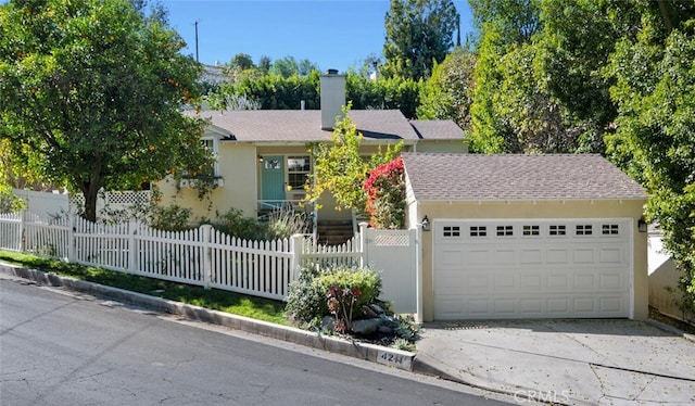 view of front of home featuring a garage, a fenced front yard, a chimney, and stucco siding