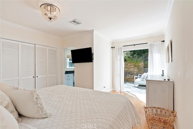 bedroom featuring access to outside, ornamental molding, and visible vents