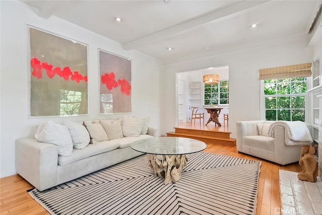 living room featuring light wood-style flooring, beam ceiling, and recessed lighting