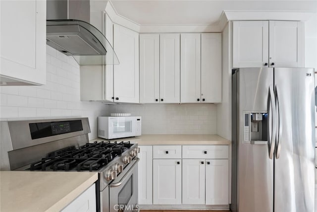 kitchen featuring stainless steel appliances, light countertops, backsplash, white cabinets, and extractor fan