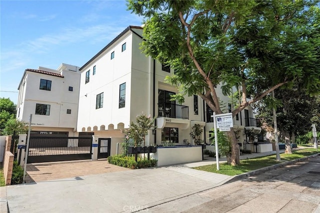 view of front facade featuring fence and stucco siding