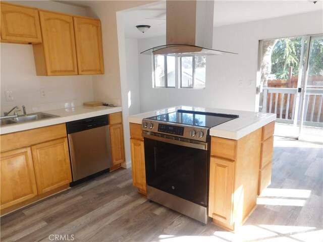 14370 Ridge Rd, Clearlake, CA 95422 - kitchen with stainless steel appliances, light countertops, a sink, island range hood, and wood finished floors