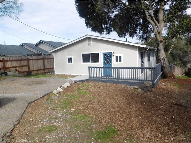 14370 Ridge Rd, Clearlake, CA 95422 - back of house featuring fence, a wooden deck, and stucco siding