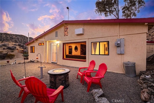 rear view of house with stucco siding and a mountain view