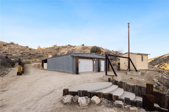 exterior space featuring driveway and an outdoor structure