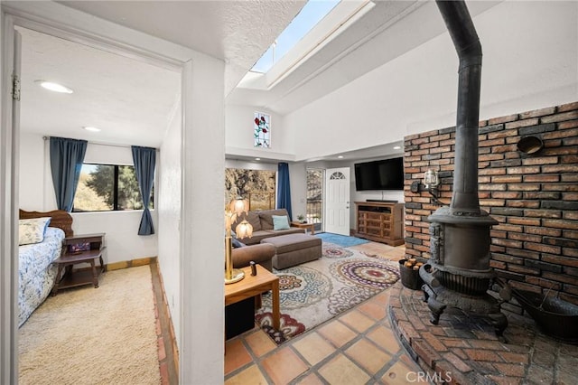 living room with baseboards, lofted ceiling, a wood stove, and recessed lighting