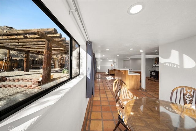 dining area featuring recessed lighting and dark tile patterned flooring