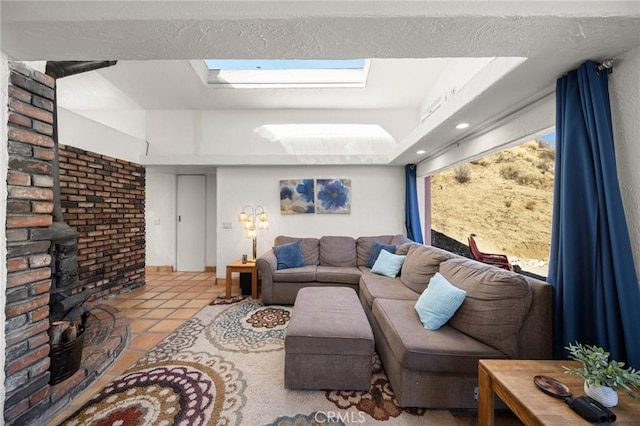 living area featuring light tile patterned floors and a skylight