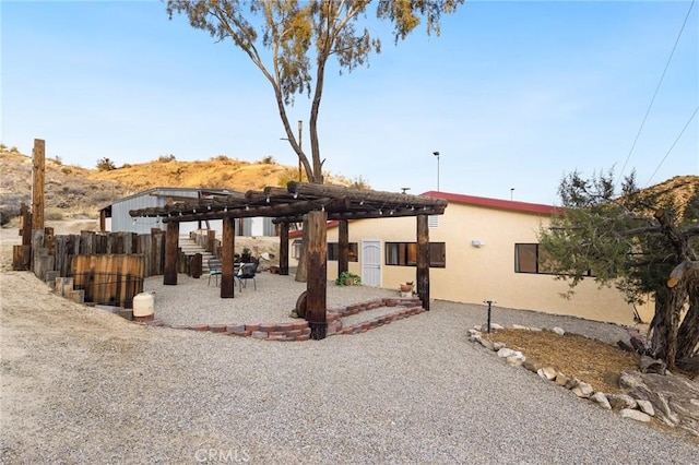 exterior space with fence, a patio, and stucco siding