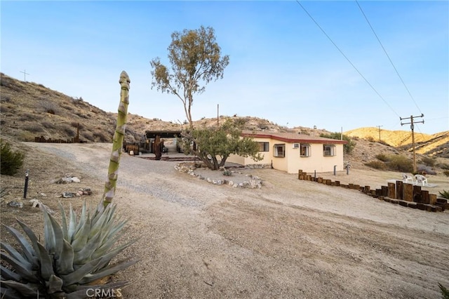 view of front of property with a mountain view and stucco siding