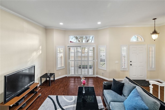 living area featuring baseboards, dark wood finished floors, crown molding, and recessed lighting