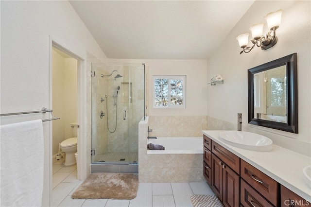 bathroom with double vanity, a stall shower, toilet, tile patterned flooring, and a bath