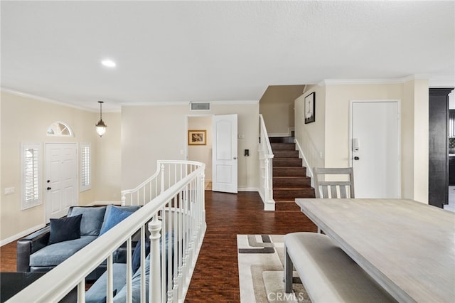 corridor featuring dark wood-style floors, visible vents, crown molding, and baseboards