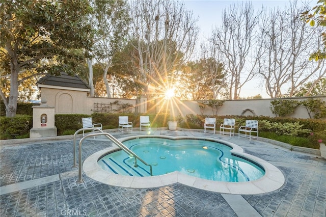 view of swimming pool featuring fence, a swimming pool, and a patio