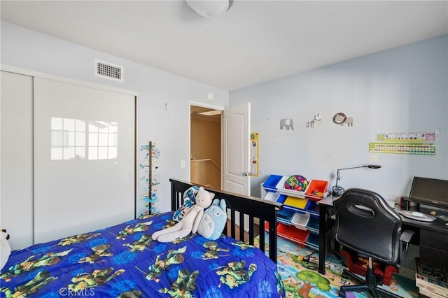 bedroom with a closet and visible vents