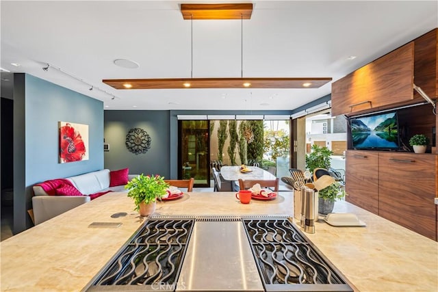 kitchen featuring cooktop, light countertops, and track lighting