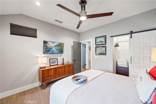 carpeted bedroom featuring ceiling fan, lofted ceiling, a barn door, visible vents, and baseboards