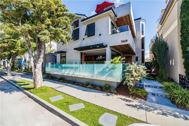 contemporary house with stucco siding