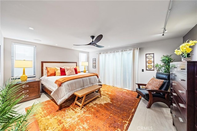 bedroom featuring rail lighting and a ceiling fan