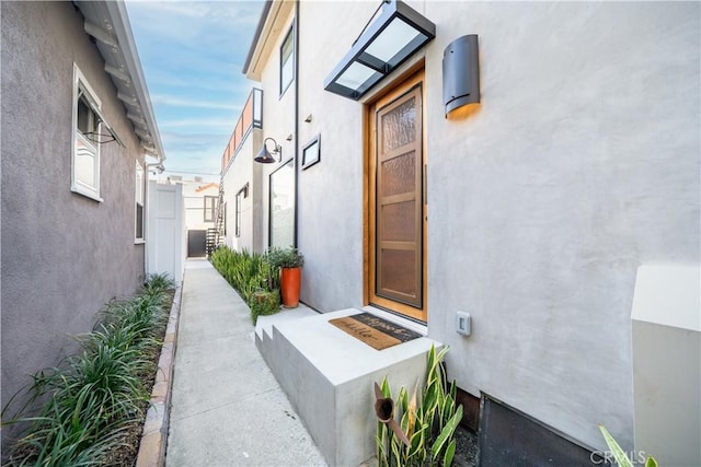 view of exterior entry featuring stucco siding