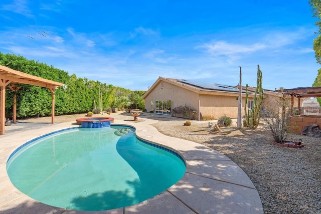 view of pool featuring a pool with connected hot tub, a pergola, and a patio