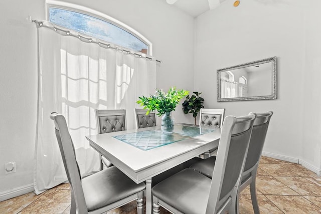 dining room featuring light tile patterned floors and baseboards