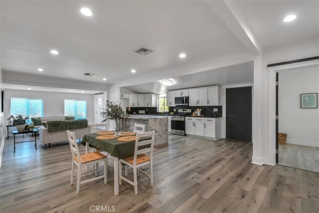 dining room featuring recessed lighting, visible vents, and light wood-style floors