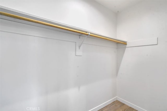 walk in closet featuring light wood finished floors