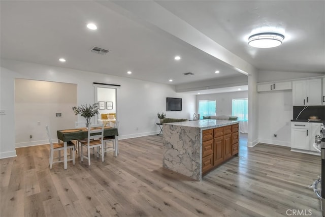 kitchen with baseboards, recessed lighting, visible vents, and light wood-style floors