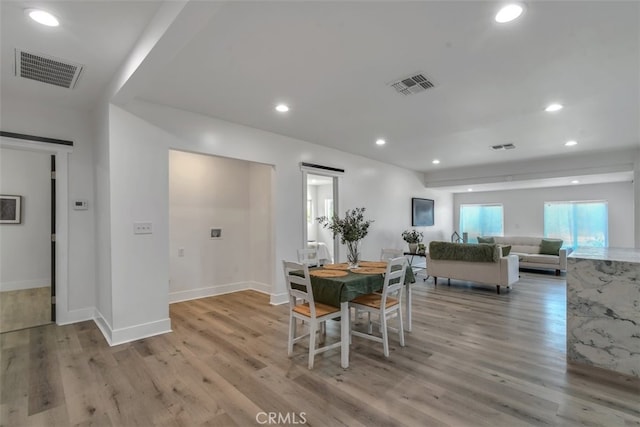 dining area featuring recessed lighting, visible vents, and wood finished floors