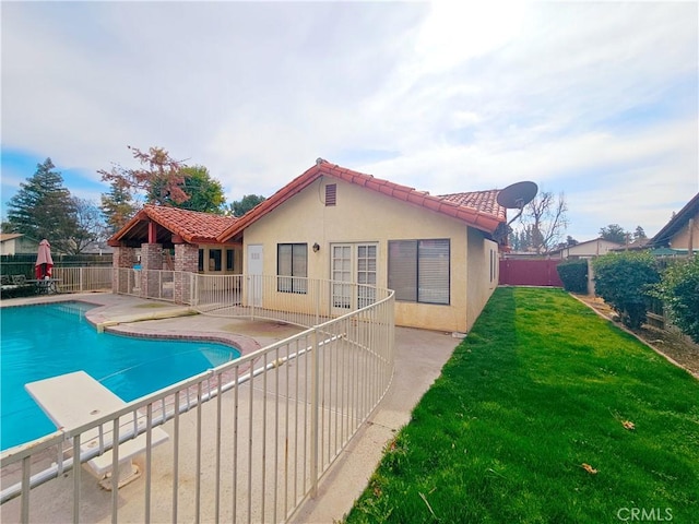 view of pool with a patio, a lawn, fence, and a fenced in pool