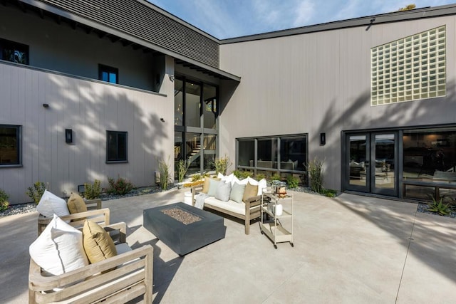 view of patio featuring french doors, stairway, and an outdoor living space with a fire pit