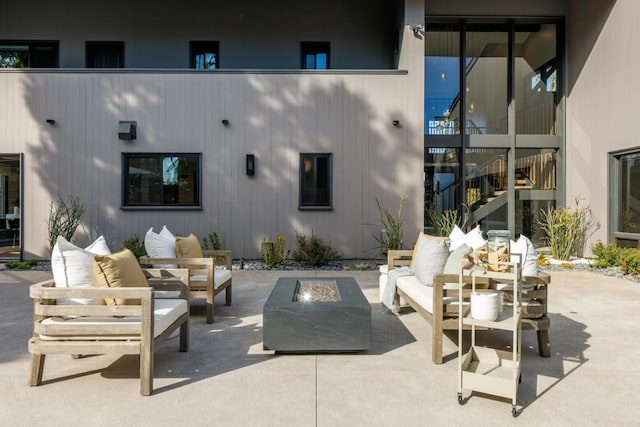 view of patio / terrace with an outdoor living space with a fire pit