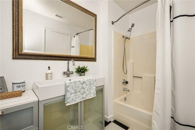 bathroom featuring shower / tub combo and visible vents