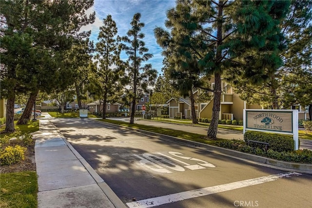 view of road featuring a residential view and curbs